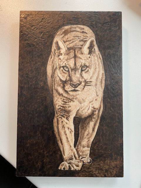Carved wooden panel with a detailed depiction of a cougar